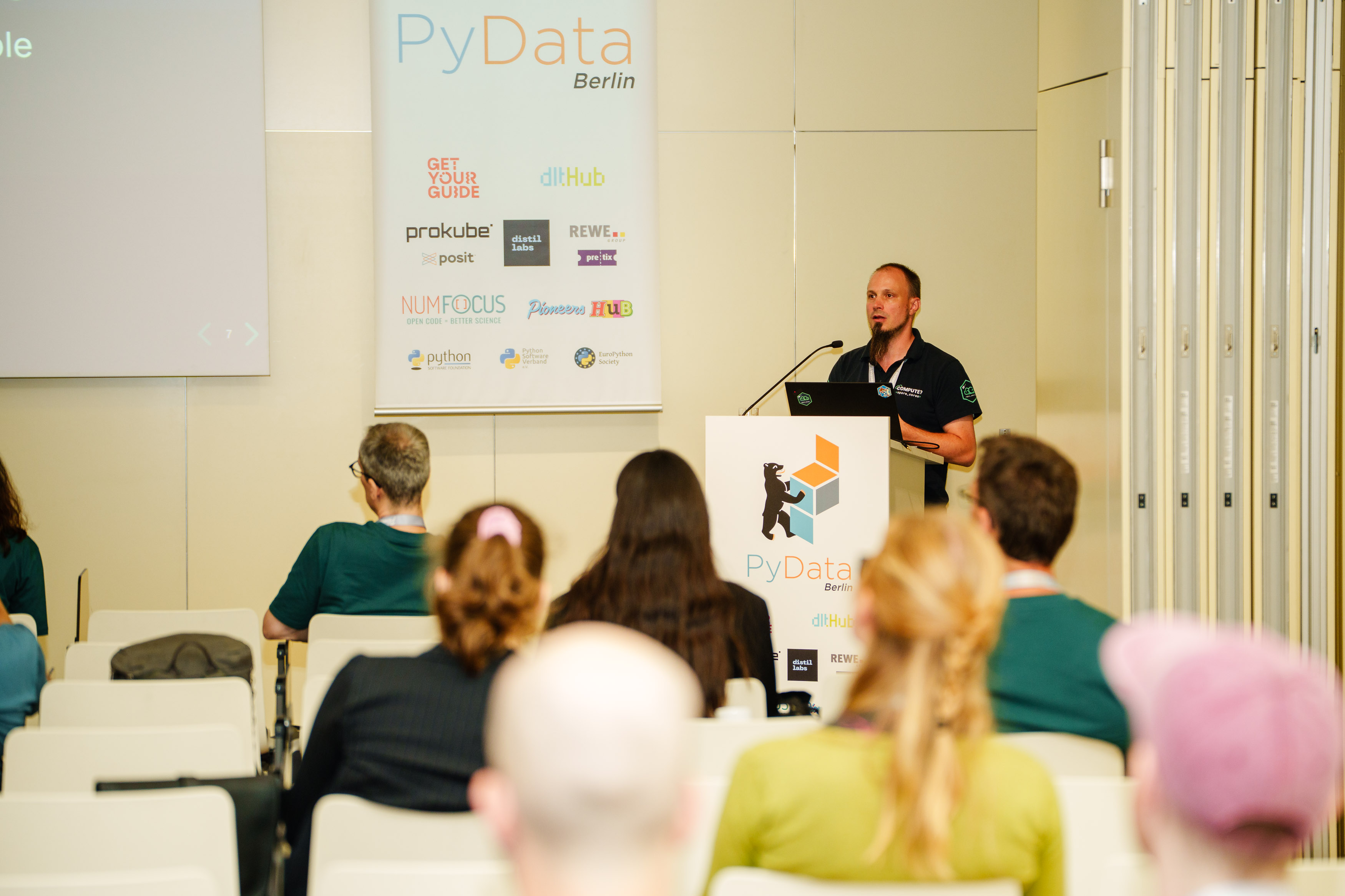 Photo of Gergely Daroczi giving a talk at the PyData Berlin 2025 conference.